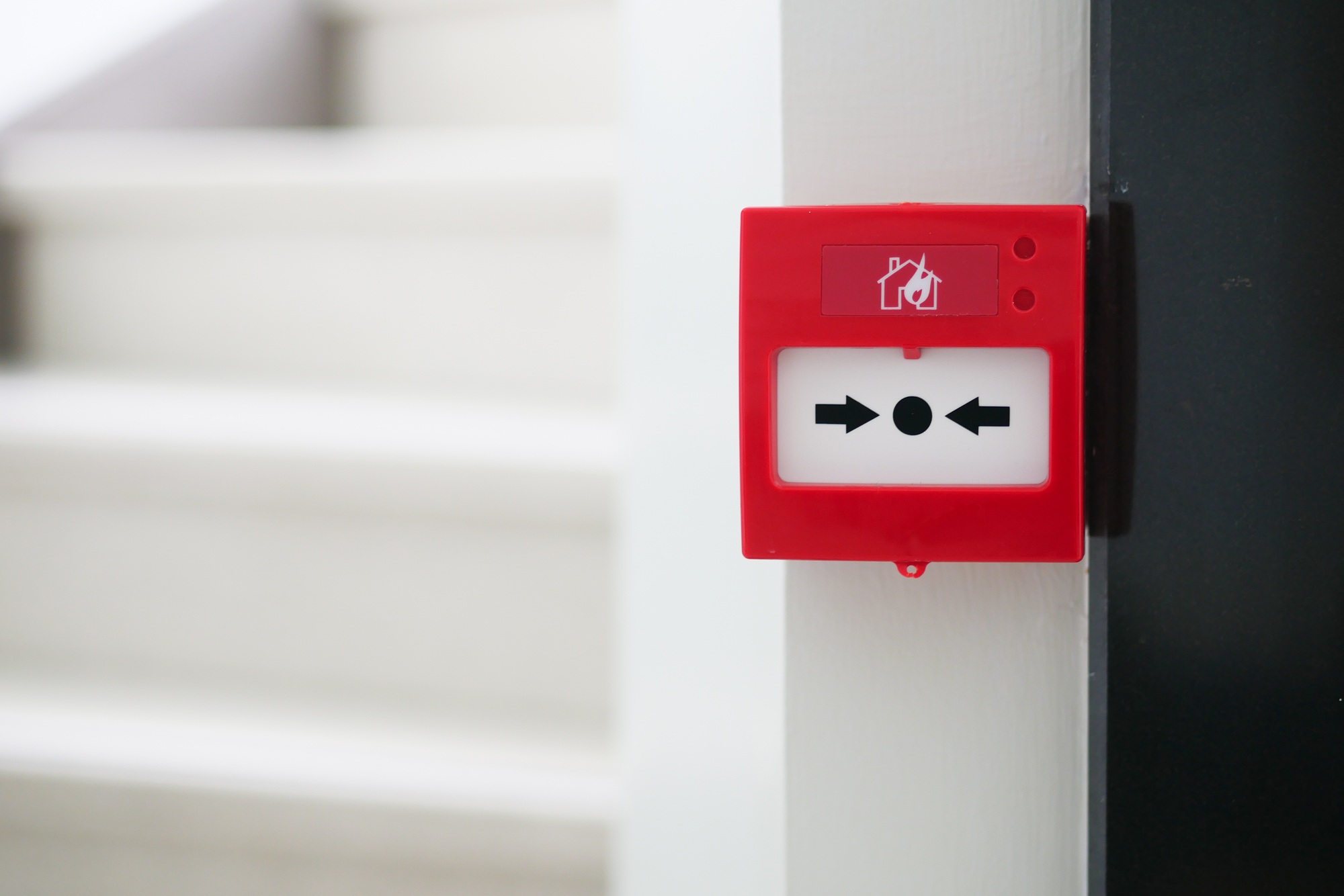 Red fire alarm button on wall ,